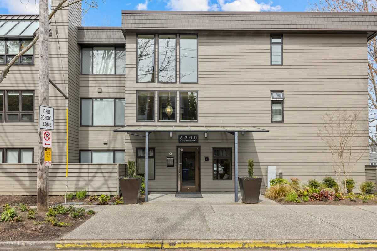 Wider exterior view of the North Seattle condominium entrance and surrounding building